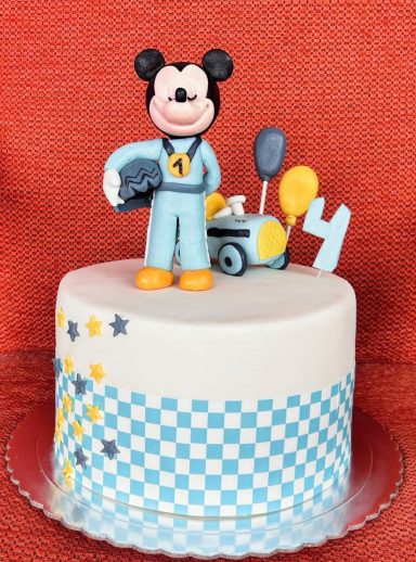 Pastel decorado con Mickey Mouse y temática de carrera, con globos y estrellas.